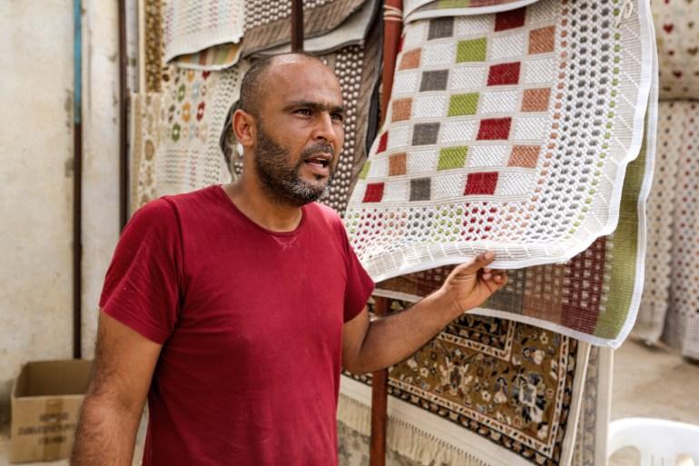 A merchant speaks in a shop at the deserted Maghreb souk of Ben Guerdane on June 4, 2021 [Fathi Nasri/AFP]
