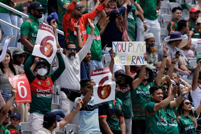 Fans react after Bangladesh's captain Najmul Hossain Shanto hit a six during the ICC Men's T20 World Cup cricket match between Bangladesh and South Africa at the Nassau County International Cricket Stadium in Westbury, New York