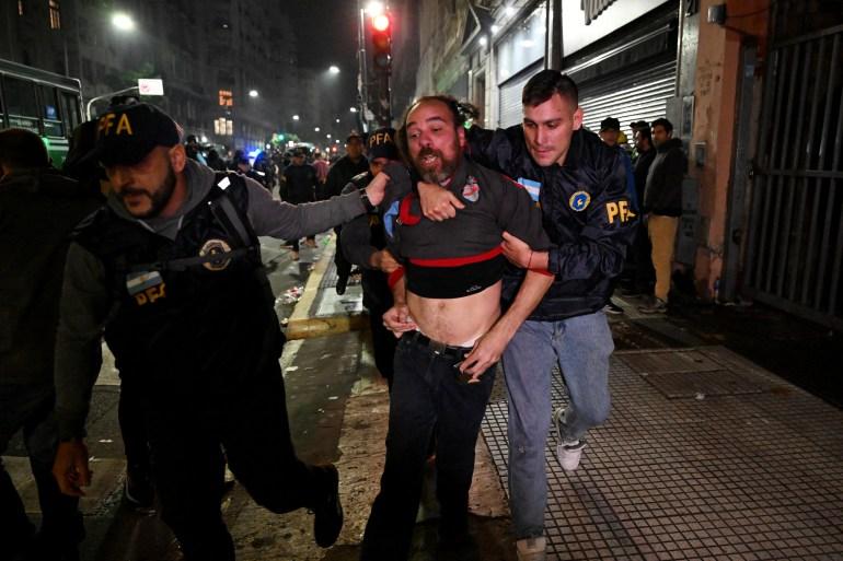 Police detain protesters angry over the proposed economic reforms in Buenos Aires [Luis Robayo/AFP]