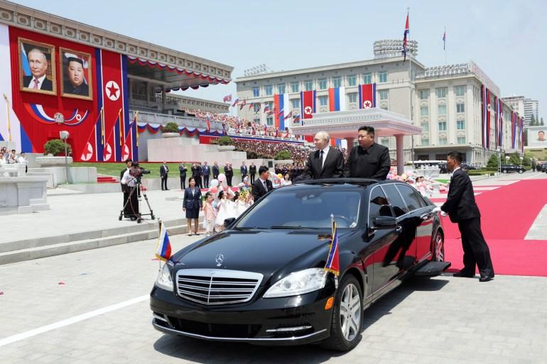 North Korea’s leader Kim Jong Un, right, and Russian President Vladimir Putin attend a welcome ceremony at Kim Il Sung Square in Pyongyang