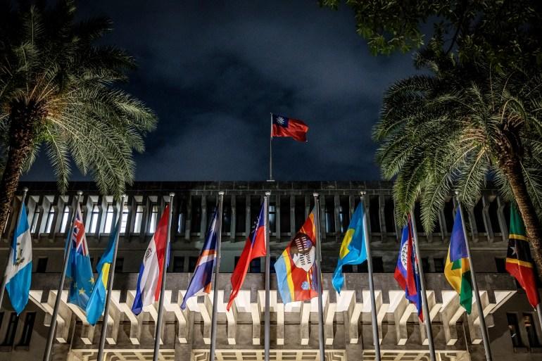Flags of Taiwan's remaining diplomatic allies on display outside the island's Ministry of Foreign Affairs.