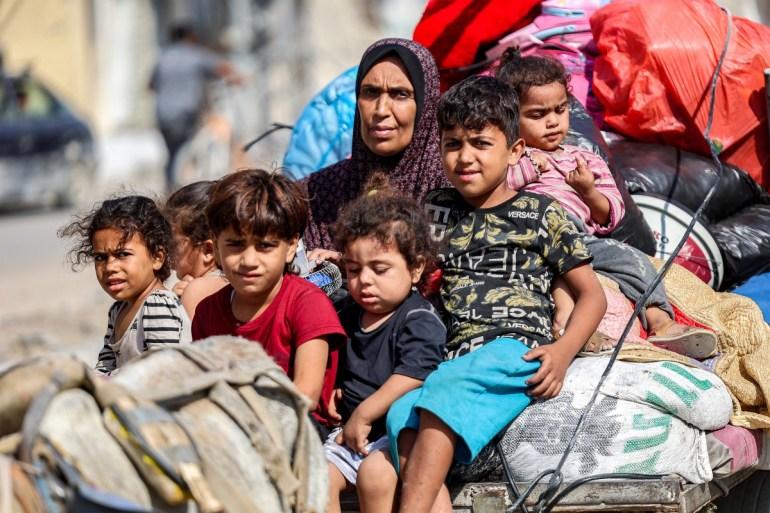 A woman and children in Tuffah Gaza City after Israel forced their evacuation