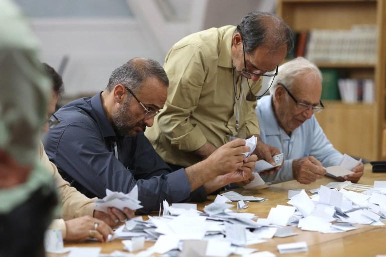 Electoral staff count ballots in a polling station after voting ended, in Tehran on June 29, 2024 [Majid Asgaripour/WANA (West Asia News Agency) via Reuters]